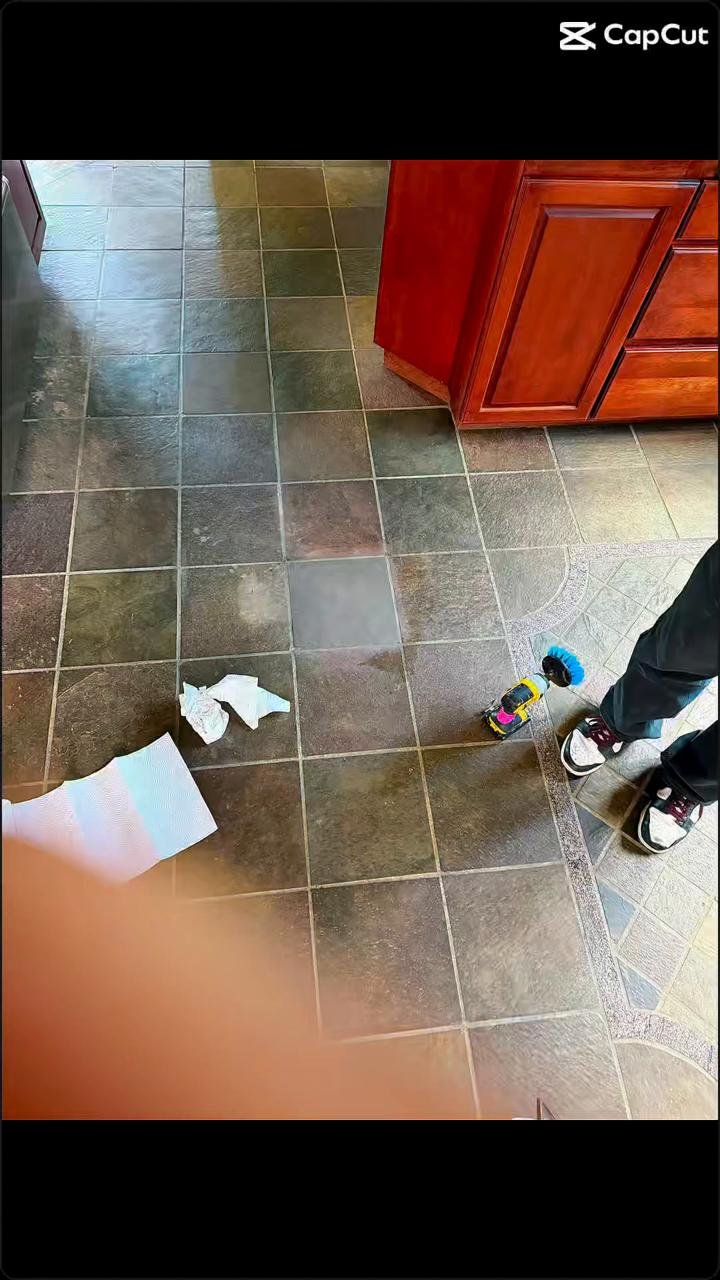 Olsen Restoration cleaning tile and grout on a floor